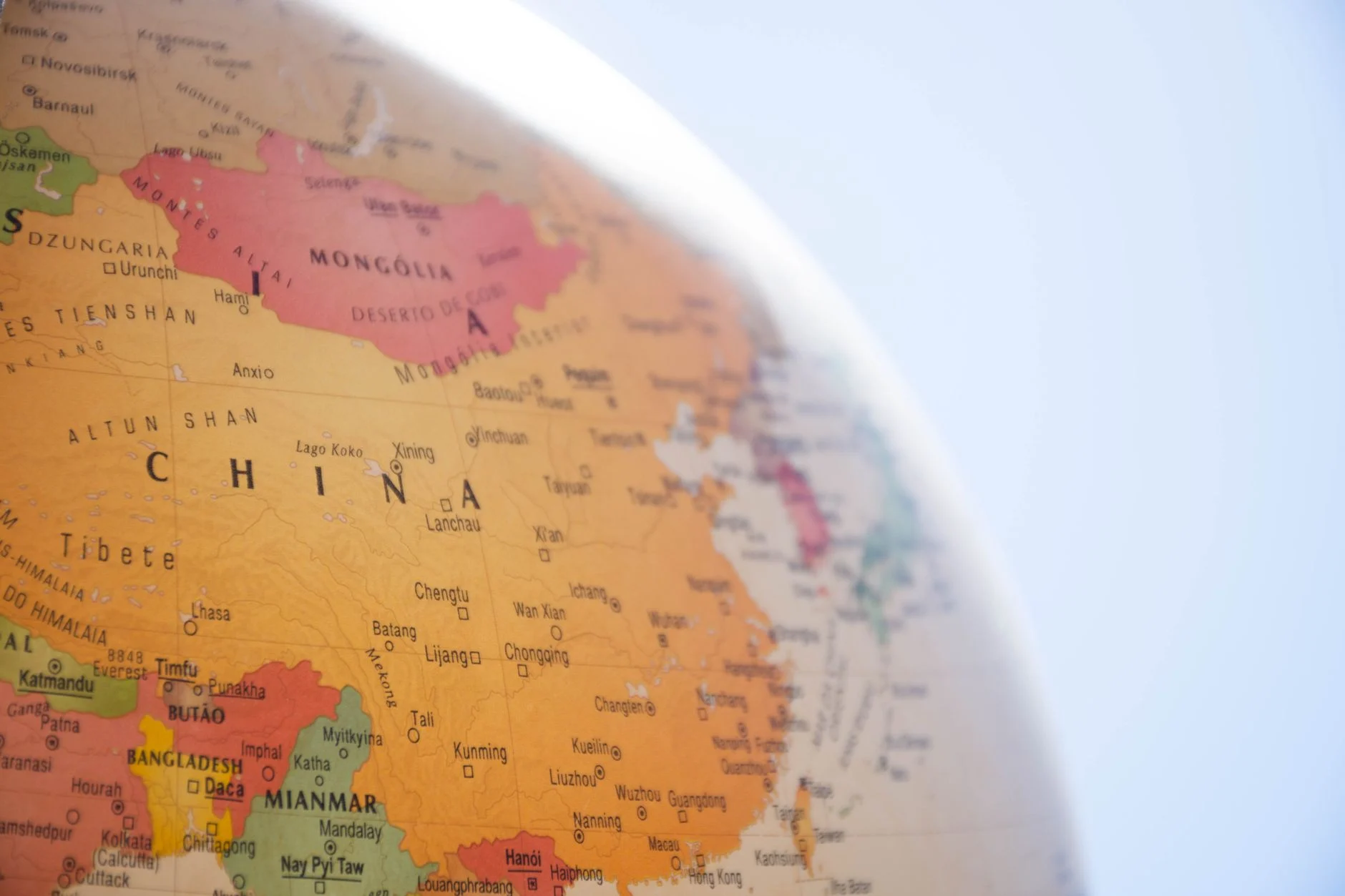 Detailed close-up of a globe showing China and surrounding regions, with geographic labels in focus.