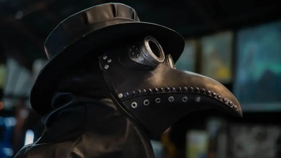 Close-up of a historically styled plague doctor mask with a beak-shaped nose.