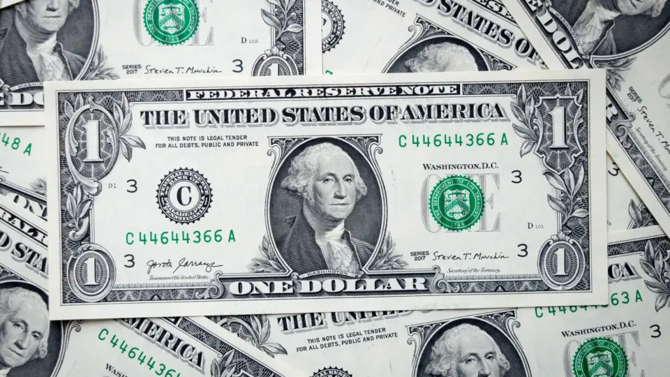 A closeup view of several stacked US dollar bills showcasing currency and financial concepts.