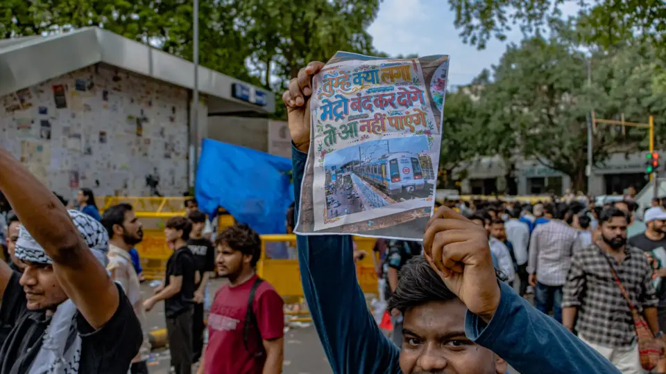 Protesters congregate at Jantar Mantar, New Delhi, holding up signs for peaceful demonstration.