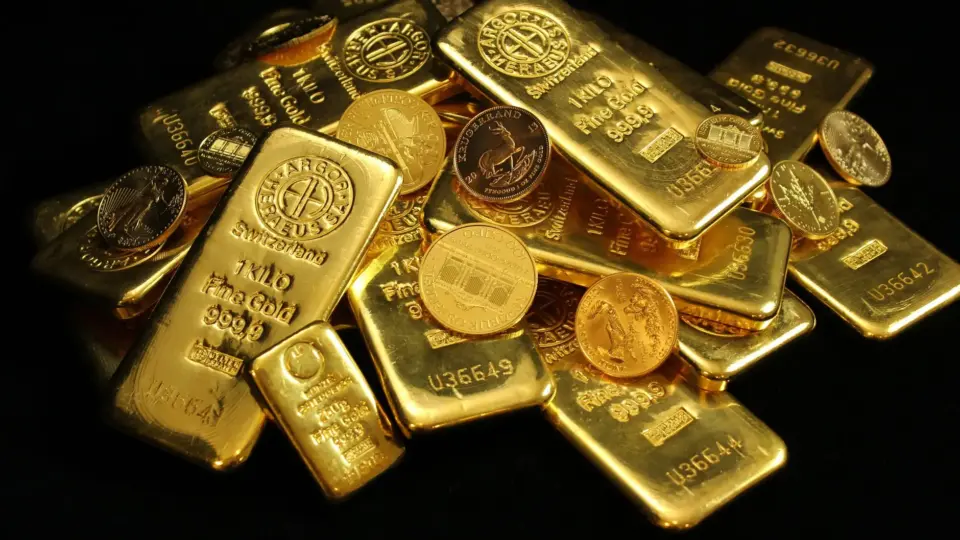 A collection of shining gold bars and coins symbolizing wealth and investment.