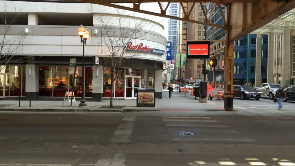 Street view of a Red Robin restaurant under an elevated railway in downtown Chicago.